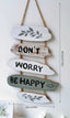 Dekoratives Wandpaneel „Don't Worry Be Happy“.